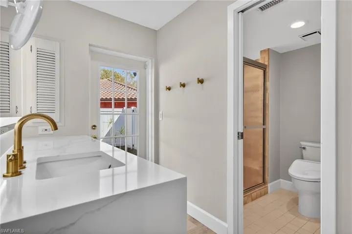 Bathroom featuring vanity and a shower stall