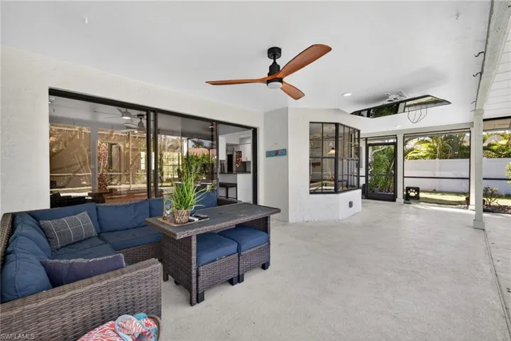 Sunroom / solarium with outdoor lounge area, ceiling fan, and a patio