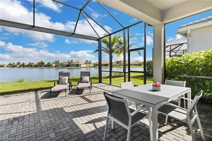 Sunroom / solarium featuring a water view