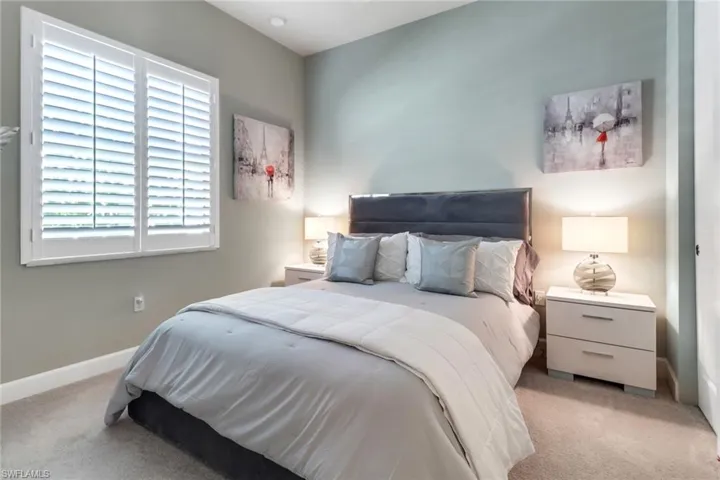 Bedroom featuring light carpet