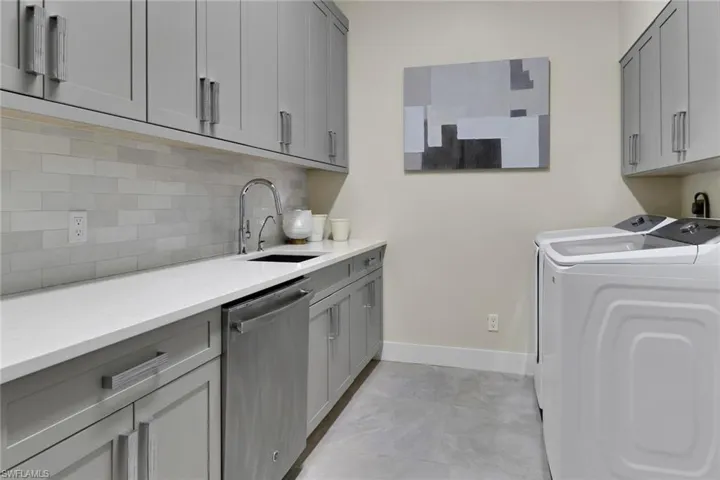Laundry room  featuring separate washer, dryer and extra dishwasher