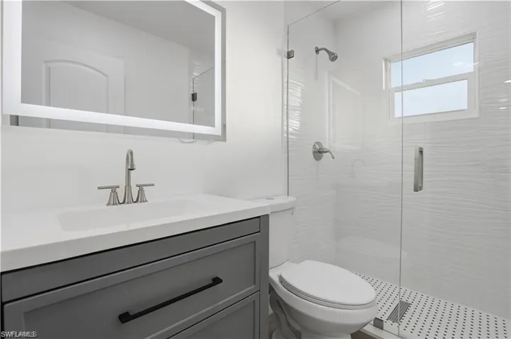 Bathroom featuring vanity and a stall shower