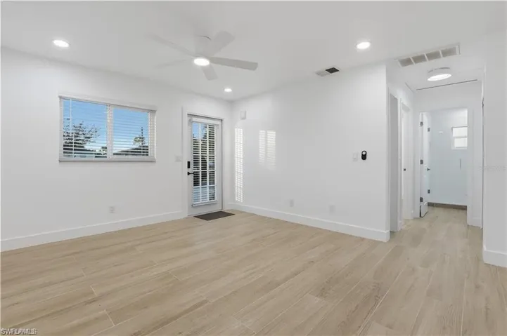 Empty room with light wood-style flooring, a ceiling fan, and recessed lighting