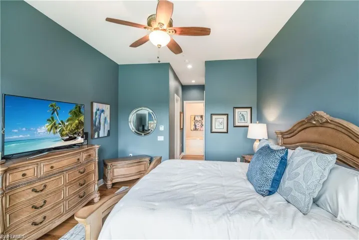 Bedroom with ceiling fan and light wood-type flooring