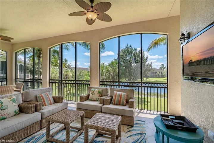 Sunroom with a ceiling fan and an outdoor living space