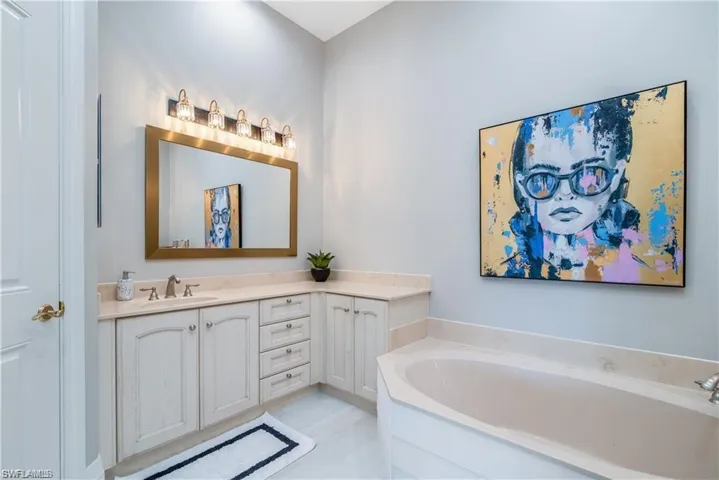 Full bath with vanity and a garden tub
