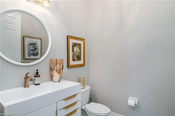 Half bathroom featuring vanity and toilet