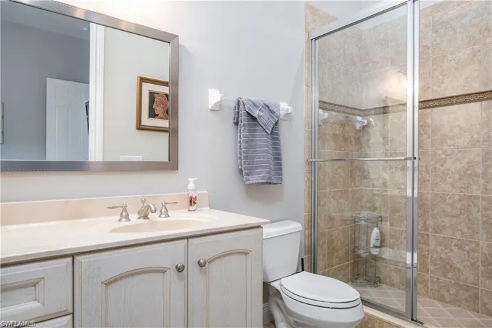 Bathroom with vanity and a shower stall