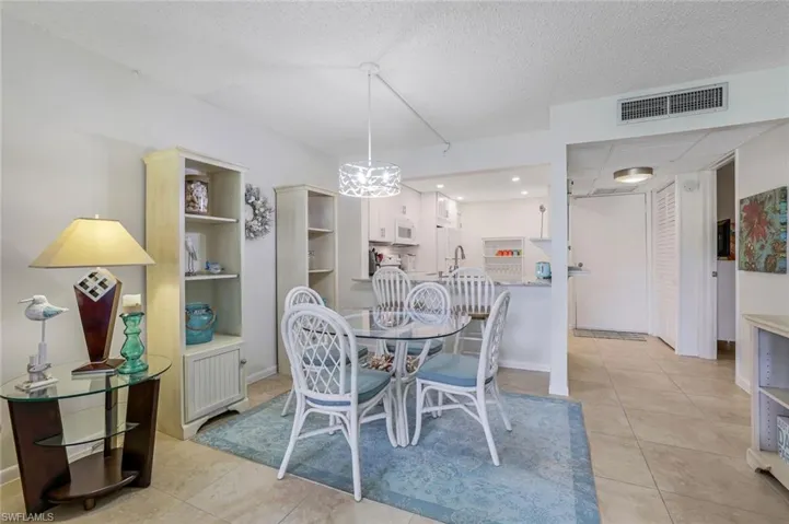 Tiled dining room featuring a textured ceiling