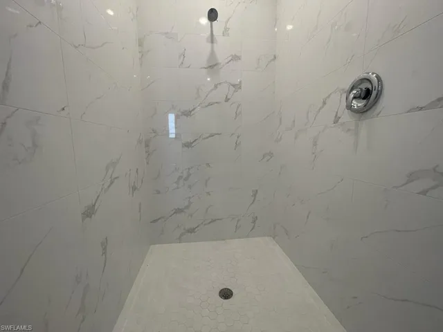 Primary Bathroom with a tile shower