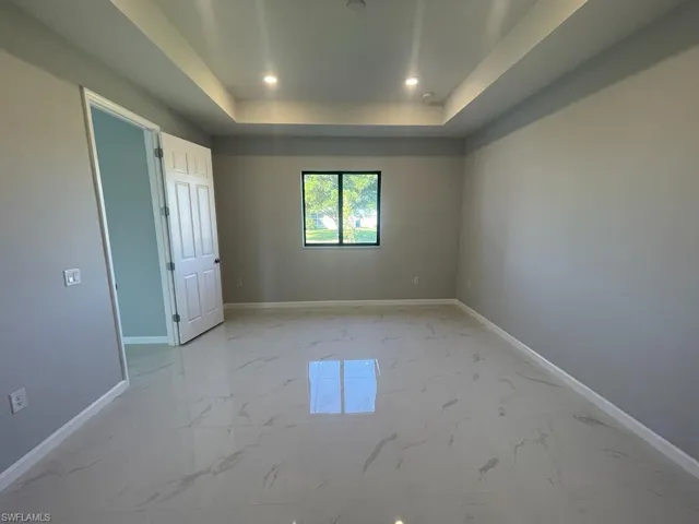 Spare room with a raised ceiling