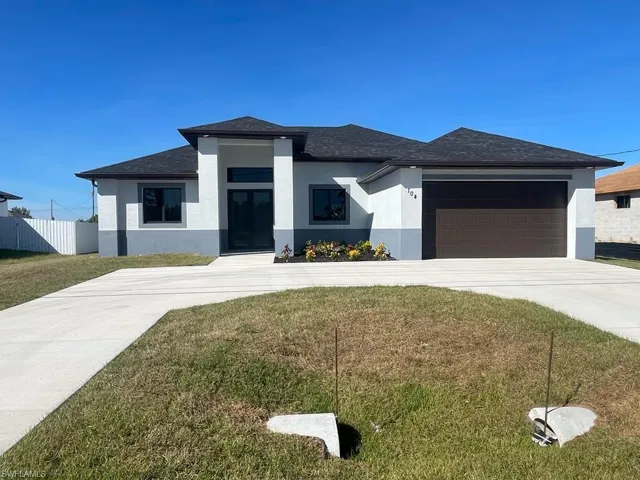 Prairie-style house with a front yard and a garage