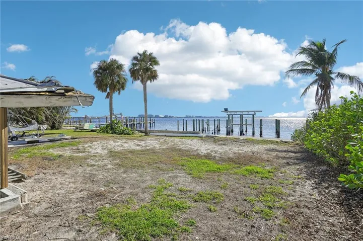 View of yard with a water view and a boat dock