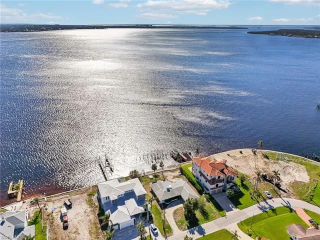 Birds eye view of property with a water view