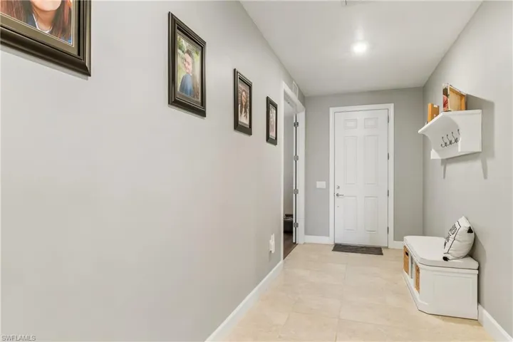 Welcoming Foyer with French Doors to Den on Left.