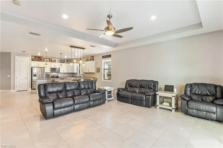 Great Room with Tray Ceiling and Recessed Lighting
