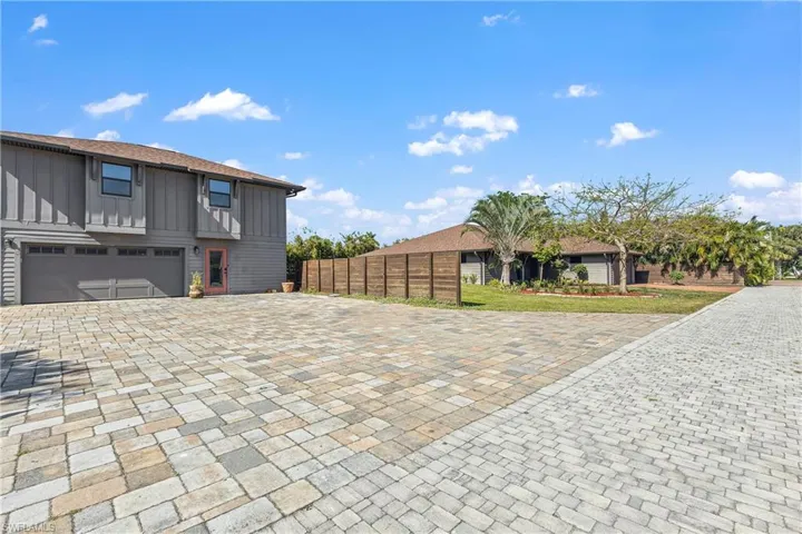 expansive lot with home, accessory unit above garage, side yard big enough for a future pool