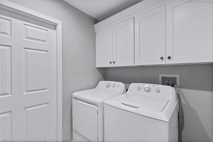 Laundry area with cabinets and independent washer and dryer