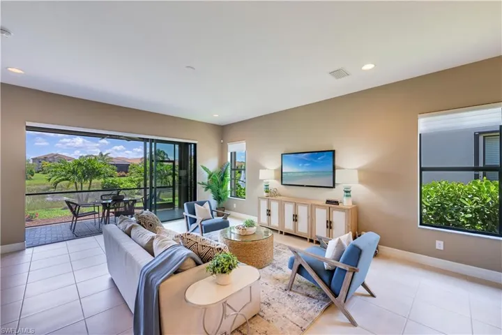 Living room featuring a healthy amount of sunlight and light tile flooring