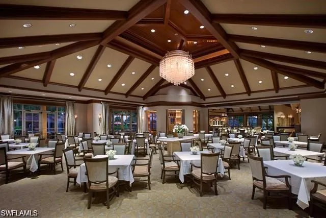 Dining space featuring a chandelier, light colored carpet, and french doors