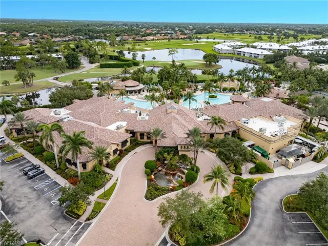 Drone / aerial view of a nearby body of water and a local golf course