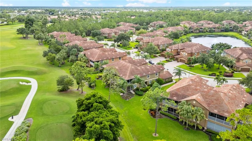 Aerial view of residential area with a large body of water and a golf course