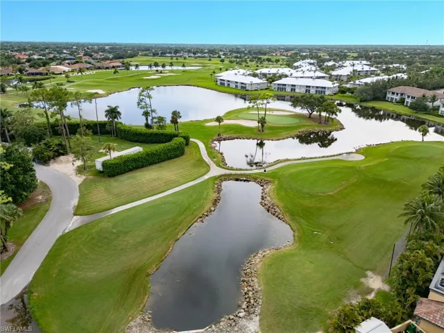 Aerial perspective of suburban area with a golf club and a nearby body of water