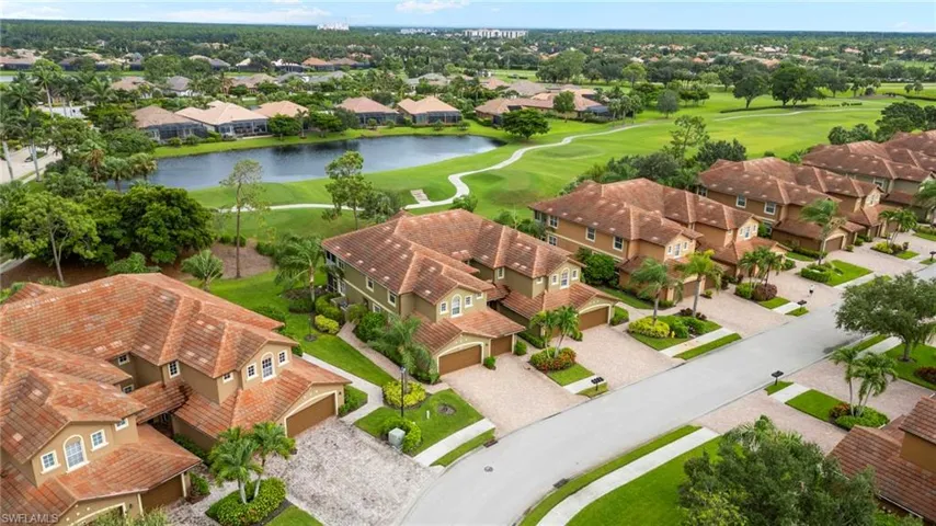 Aerial view of residential area with a large body of water and a golf club