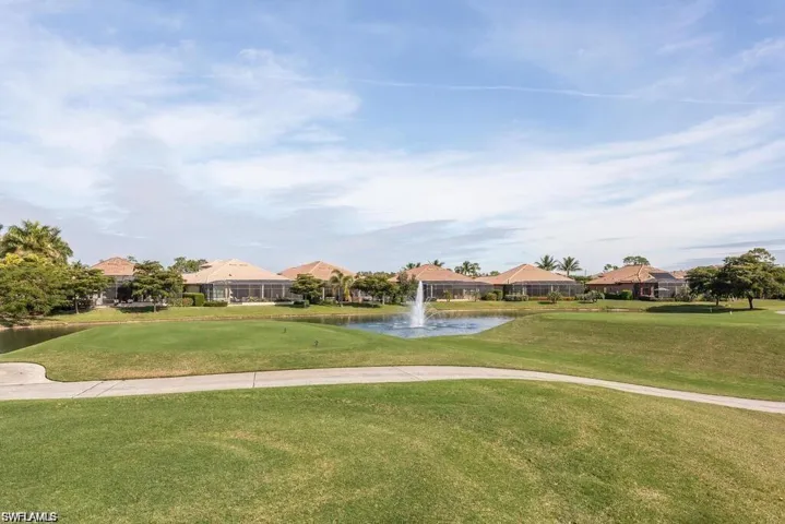 View of home's community featuring a water view, a lawn, and a residential view