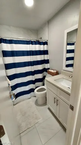 Bathroom with vanity and a shower with shower curtain