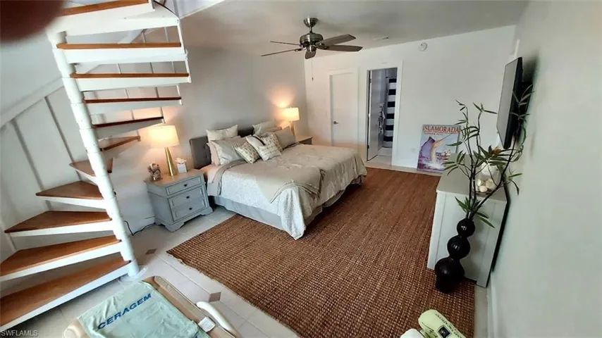Bedroom with tile patterned floors and a ceiling fan