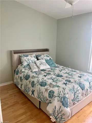 Bedroom featuring wood finished floors and ceiling fan