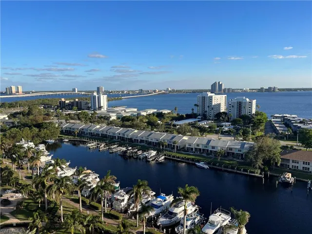 Aerial view of property and surrounding area with a nearby body of water and nearby urban area