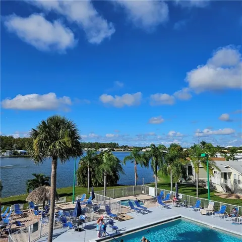 Community pool with a patio and a water view