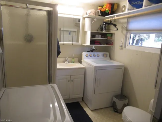 Full bath featuring a washer/dryer.