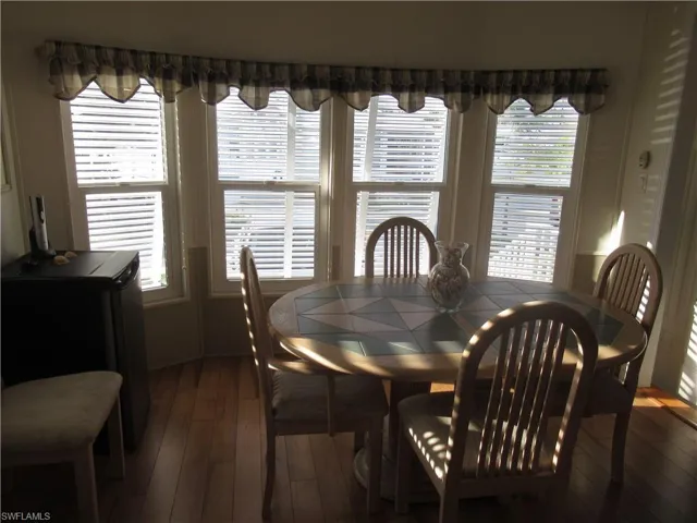 Dining room featuring dark wood-type flooring and plenty of natural light