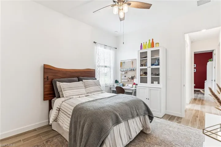 Bedroom featuring ceiling fan and wood-type flooring