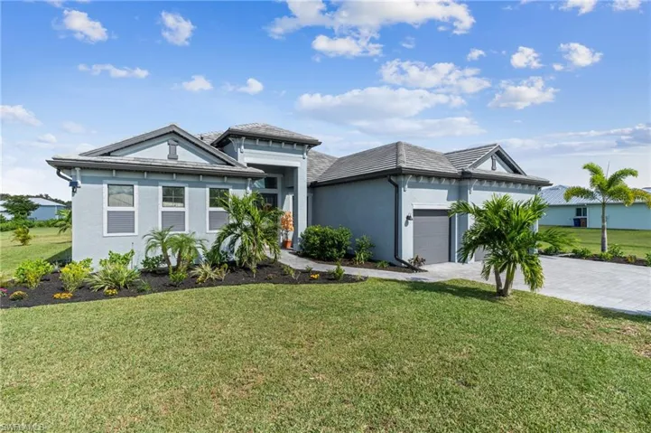 View of front facade with a front yard and a garage