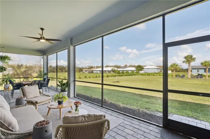 Sunroom / solarium featuring ceiling fan
