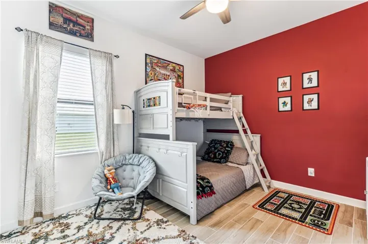 Bedroom with ceiling fan and light hardwood / wood-style flooring