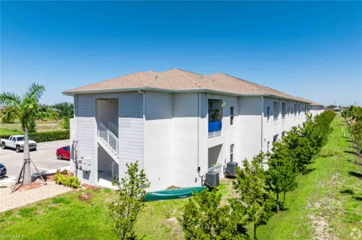 View of property exterior featuring stucco siding and a yard