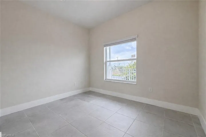 Spare room with baseboards and light tile patterned floors