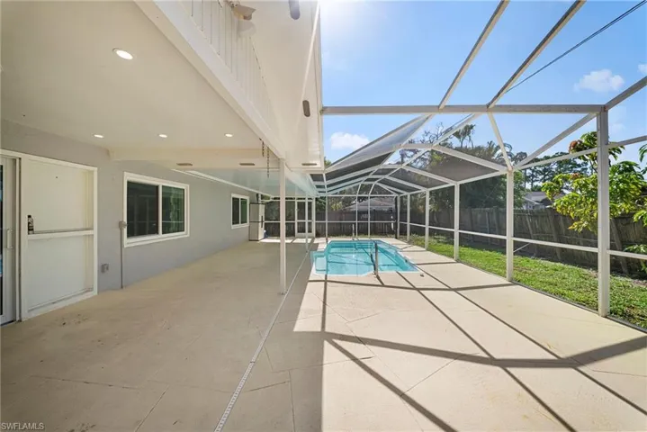 Screened enclosure with an in-ground pool and an expansive concrete patio