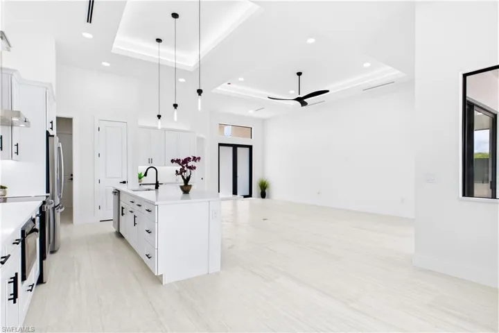 Living, dining, kitchen, and primary suite feature RECESSED CEILINGS accented by sleek LED TRACK lighting.