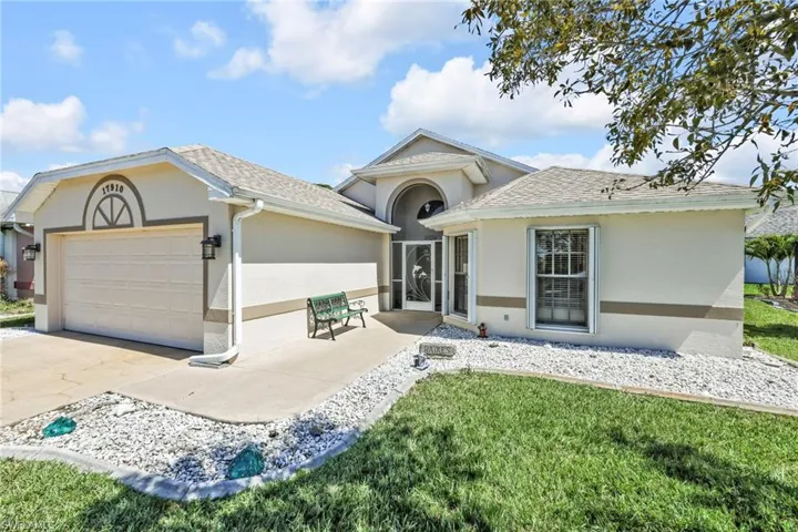 0 maintenance yard, 2 car driveway, an attached full 2 car garage, shingled roof, stucco siding, and screened enclosure