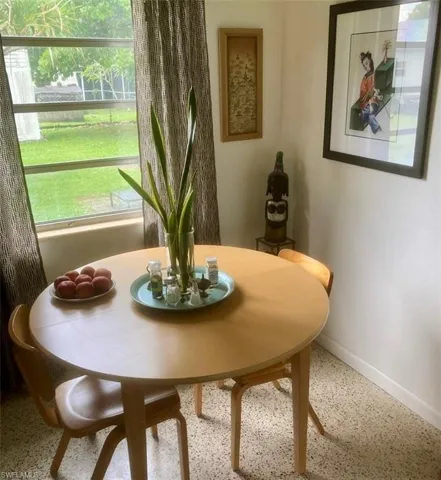 Dining space with baseboards and speckled floor