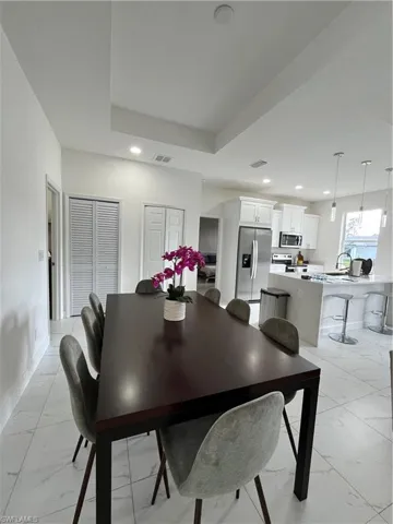 Dining room featuring marble finish floor, baseboards, visible vents, and recessed lighting