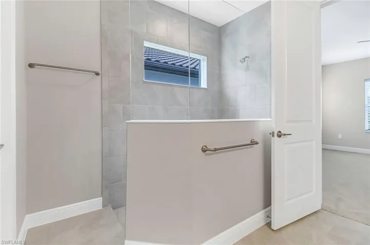 Full bathroom with baseboards and a walk in shower