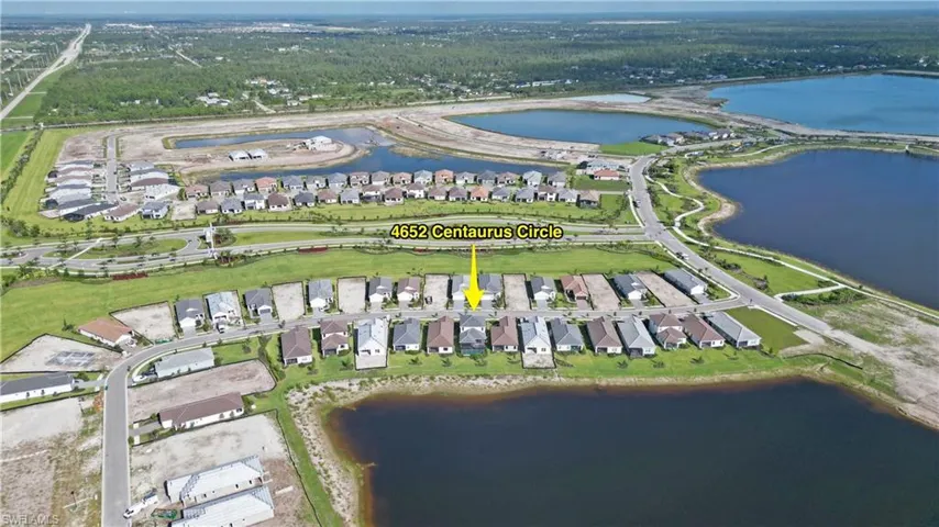 View of property location with nearby suburban area and a nearby body of water