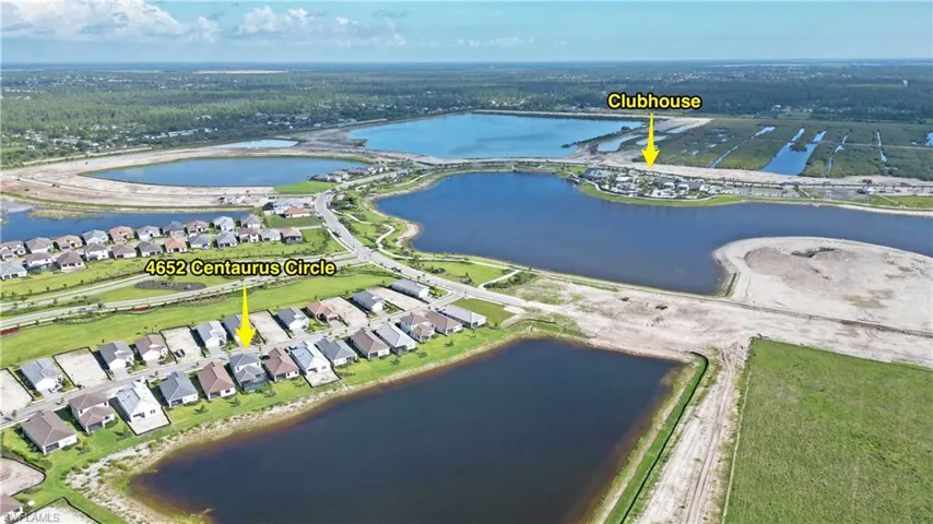 View of property location featuring a large body of water and nearby suburban area